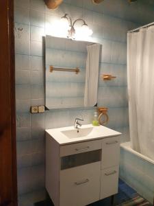 a bathroom with a sink and a mirror and a tub at Can More El Pasteral in La Cellera de Ter