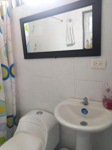 a bathroom with a sink and a toilet and a mirror at LA MESA CUND, APTO CONJUNTO GETSEMANI in La Mesa