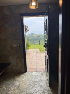 a door to a room with a view of a pathway at Prau del Urogallo in Ribadesella