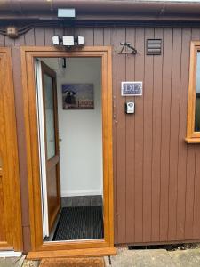 uma porta para um edifício com um sinal em S and S Chalets - 2 - Mablethorpe em Mablethorpe