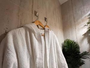 a white robe is hanging on a wall at Zaya luxury apartment in Riyadh
