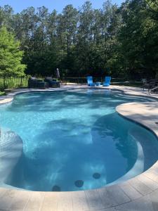 a large pool with blue water in a yard at The Meadow Cabin in Folsom