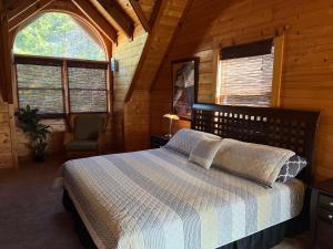 a bedroom with a bed in a wooden cabin at Airport Runway 33 in Pigeon Forge