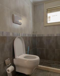 a bathroom with a toilet with the lid up at Dhori House Dhermi in Dhërmi