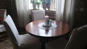a candle sitting on top of a wooden table at Stadshotellet Sölvesborg in Sölvesborg