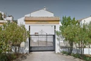 a white building with a gate in front of it at VFT DOÑA ELVIRA SIERRA in Virgen de la Cabeza