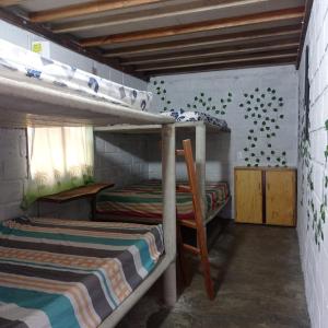 a bedroom with two bunk beds and a window at Cabaña Palmeras del Viento in San Bernardo del Viento