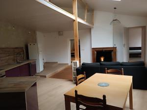 a living room with a table and a couch at Maison meublé au centre de Luc in Luc-en-Diois