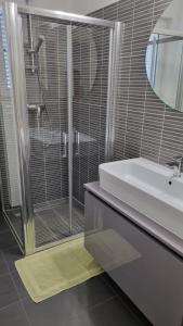 a bathroom with a shower and a white sink at Casa Emma in Poreč