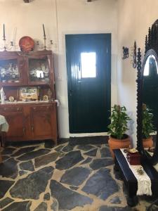 a room with a black door and a window at Quintinha dos Pombinhos in Montoito