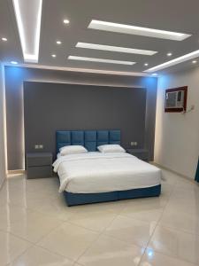 a bedroom with a large bed with blue lighting at شقق ضيافة رغد 2 in Al Madinah