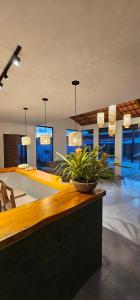 - un salon avec une table et une plante dans l'établissement Pousada Alkamar Quarto comfort, à Maragogi