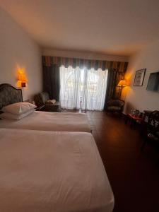 a hotel room with two beds and a window at Domina coral bay resort in Sharm El Sheikh