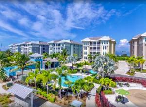 an aerial view of a resort with a pool and palm trees at Bungalow at Margaritaville! Less than 1 Mile to AMI! in Bradenton
