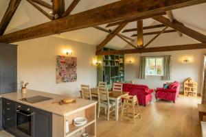 a kitchen and living room with a table and chairs at Wood Cottage in York