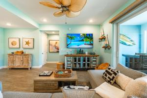 a living room with a couch and a ceiling fan at Bungalow at Margaritaville! Less than 1 Mile to AMI! in Bradenton