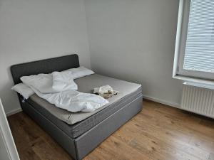 a unmade bed in a corner of a room at GardenLoft Terrace no 3 in Vienna