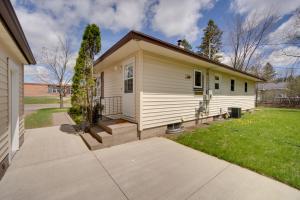 a small white house with a driveway at Sunny Cloquet Home - 2 Mi to St Louis River! in Cloquet