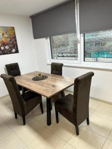 a dining room table with chairs and a window at Danube Island Apartment 3 in Vienna