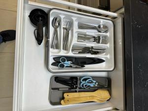 a drawer full of utensils in a refrigerator at Danube Island Apartment 3 in Vienna