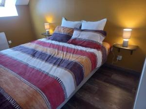 Saint-Georges-le-FléchardにあるGîte de la Petite Noërie - 11 personnesのベッドルーム1室(ランプ2つ付) +2枚の写真