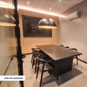 a dining room with a black table and chairs at Departamento en Belgrano Capital Federal in Buenos Aires