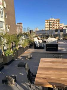 a patio with benches and a wooden table and chairs at Departamento en Belgrano Capital Federal in Buenos Aires