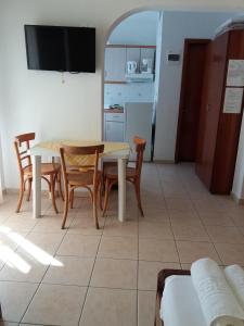 a kitchen and dining room with a table and chairs at House Maria Manolaki, 1st Floor Studios in Vourvourou