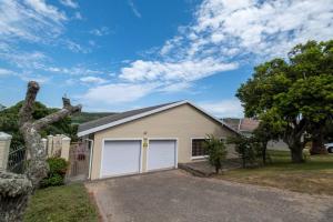 a house with a garage in a yard at Selah-on-Sea in Kenton on Sea