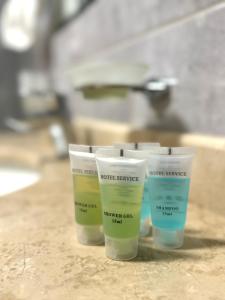 three containers of moisturizers sitting on top of a counter at Full Comfort Apartment at Chavchavadze in Tbilisi City +113 photos