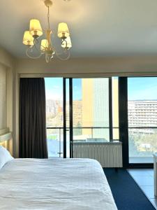 a hotel room with a bed and a large window at Full Comfort Apartment at Chavchavadze in Tbilisi City