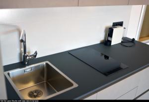 a kitchen counter top with a sink and aounter at Val De Laco studio apartments in Rovinj