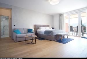 a bedroom with a bed and a couch and a table at Val De Laco studio apartments in Rovinj