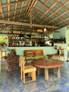 a room with a table and chairs and a bar at Casa Alma in Capurganá