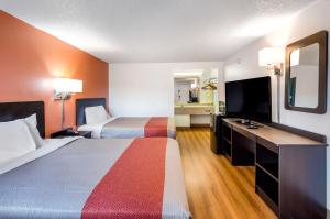 a hotel room with two beds and a flat screen tv at Motel 6-Salem, VA in Salem