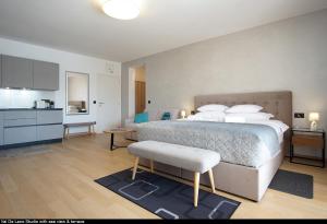 a bedroom with a large bed and a kitchen at Val De Laco studio apartments in Rovinj +19 photos