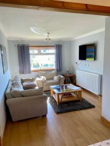 a living room with a couch and a coffee table at Fort William - Highland holiday home in Fort William