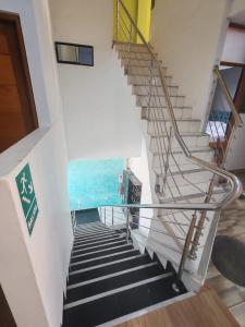 a spiral staircase in a building with a view of the ocean at HOTEL EL TREBOL in Yurimaguas