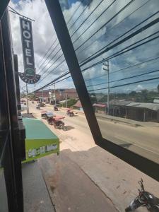 a view of a street from a window of a gas station at HOTEL EL TREBOL in Yurimaguas