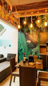 a living room with a wall with a mural of plants at Ninho de Aço - Casa Container! in Uberlândia