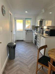 a kitchen with a counter and a table and a chair at Annie's Hideaway in Chapel Saint Leonards