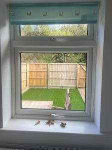 a window in a room with a view of a yard at Annie's Hideaway in Chapel Saint Leonards