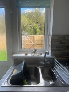 a kitchen with a sink and a window at Annie's Hideaway in Chapel Saint Leonards
