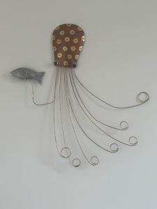 a fish hanging on a wall with a bow at Annie's Hideaway in Chapel Saint Leonards