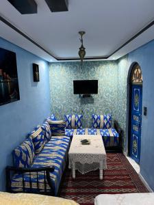 a living room with a couch and a table at Dar Ghita Medina in Rabat
