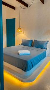 ein Schlafzimmer mit einem großen Bett, auf dem eine Lampe hängt in der Unterkunft Sollaris in Amontada