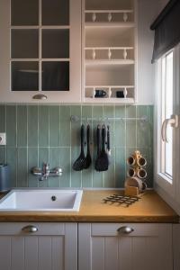 a kitchen with a sink and a counter with utensils at Villa Natalia in Kalami