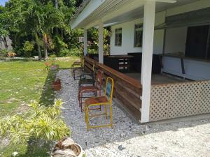 a porch of a house with chairs and a table at Chez Angele in Faie