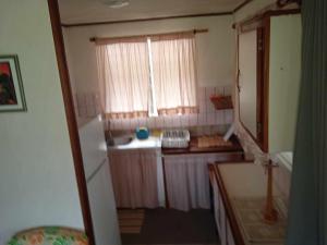 a small room with a window and a sink at Chez Angele in Faie