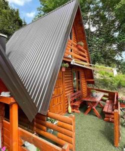 a log cabin with a picnic table in front of it at Konak kod Tose in Banja Luka